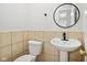 Small bathroom with pedestal sink and beige tile at 6609 St James Dr, Indianapolis, IN 46217