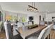 Spacious dining area with a long wooden table, offering a view into the living room and kitchen at 713 Penrose Pl, Danville, IN 46122