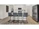 Modern kitchen with island, stainless steel appliances, and gray barstools at 713 Penrose Pl, Danville, IN 46122