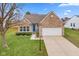 Brick house with a two car garage and landscaping at 746 Downing Dr, Greenwood, IN 46143