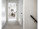 Bright hallway with grey carpet and a view into a bedroom at 849 N Oakland Ave, Indianapolis, IN 46201