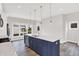 Open concept kitchen with island, stainless steel appliances, and hardwood floors at 2829 Macpherson Ave, Indianapolis, IN 46205