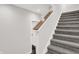 Modern staircase with carpeted steps and wood handrail at 2829 Macpherson Ave, Indianapolis, IN 46205