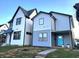 Two-story modern home with gray and white siding, a light blue door, and landscaping at 305 Parkway Ave, Indianapolis, IN 46225