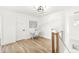 Bright hallway with wood floors, a built-in desk, and upper level access at 305 Parkway Ave, Indianapolis, IN 46225