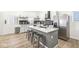 Modern kitchen with gray island, white cabinets, and stainless steel appliances at 305 Parkway Ave, Indianapolis, IN 46225