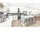 Contemporary kitchen with white cabinets, gray island, and stainless steel appliances at 305 Parkway Ave, Indianapolis, IN 46225