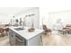 Kitchen island with a farmhouse sink and a view into the dining and living areas at 305 Parkway Ave, Indianapolis, IN 46225