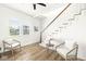 Light and airy living room with hardwood floors and stairs at 305 Parkway Ave, Indianapolis, IN 46225