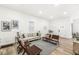 Bright living room with hardwood floors, comfy seating, and a view into the hallway at 305 Parkway Ave, Indianapolis, IN 46225