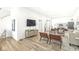 Open living space with hardwood floors, modern furniture, and a view into the kitchen at 305 Parkway Ave, Indianapolis, IN 46225