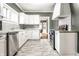 Modern white kitchen with marble countertops and stainless steel appliances at 320 N Lesley Ave, Indianapolis, IN 46219