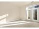 Spacious bedroom with neutral walls and carpet, and access to a balcony at 355 E Ohio E St # 324, Indianapolis, IN 46204