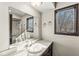 Bathroom with sink, mirror, and view into shower at 409 Lansdowne Rd, Indianapolis, IN 46234