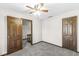 Bedroom with ceiling fan and wooden doors at 409 Lansdowne Rd, Indianapolis, IN 46234