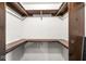 Large closet with wooden shelving and rods at 409 Lansdowne Rd, Indianapolis, IN 46234