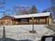 Brick ranch house with covered porch, snow-covered yard at 2610 N 350 W, Anderson, IN 46011