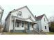 Two-unit building, light gray siding, front porches, and steps at 604 Lincoln St, Indianapolis, IN 46203