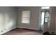 Empty living room with carpet, window, and door at 604 Lincoln St, Indianapolis, IN 46203