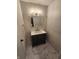 Stylish bathroom with dark vanity and marble floor at 6805 E County Road 100 S, Avon, IN 46123