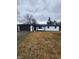 White brick ranch house with black accents, a dark garage door, and a spacious yard at 6805 E County Road 100 S, Avon, IN 46123