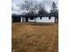 Newly renovated ranch home with white brick exterior, black accents, and a long driveway at 6805 E County Road 100 S, Avon, IN 46123