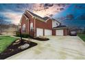 Brick house with three-car garage and manicured lawn at 2569 Dawn Ridge Dr, Carmel, IN 46074