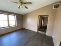 Spacious living room with dark laminate flooring and ceiling fan at 3088 N Alaska Rd, Cloverdale, IN 46120