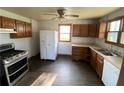 Kitchen with wood cabinets, stainless steel appliances, and dark flooring at 3088 N Alaska Rd, Cloverdale, IN 46120