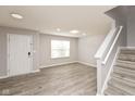 Bright living room with hardwood floors and neutral walls at 5321 Basin Park Dr, Indianapolis, IN 46239