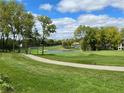 Picturesque golf course view with a pond and tree-lined fairways at 1366 Forest Hills Dr, Westfield, IN 46074
