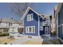 Two-story blue house with white accents and a spacious backyard at 412 W 11Th St, Anderson, IN 46016