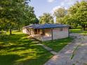 Brick ranch house with a covered porch and ample yard space at 2129 Woodcrest Rd, Indianapolis, IN 46227