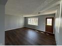 Bright living room with dark hardwood floors and neutral walls at 7969 N Royerton Park Dr, Muncie, IN 47303