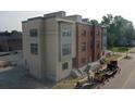 Modern tan and red brick townhouses under construction at 98 E Wayne St # D, Franklin, IN 46131