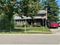 Ranch-style home with carport and well-maintained lawn at 643 Pratt St, Greenfield, IN 46140