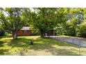 Brick ranch house with attached garage, ample yard space, and mature trees at 3910 N State Road 135, Franklin, IN 46131