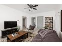 Virtually staged living room with a couch, chair, and TV at 1229 Spann Ave, Indianapolis, IN 46203