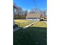 Side yard with walkway to detached garage at 6104 Madison Ave, Indianapolis, IN 46227