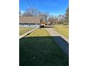 Gravel driveway and grassy yard at 6104 Madison Ave, Indianapolis, IN 46227