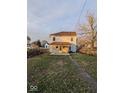 Home's backyard with a wooden deck and a grassy area at 213 E Broadway St, Alexandria, IN 46001