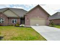 Brick ranch home with 2-car garage and landscaped lawn at 2749 Stones Bay Dr, Greenwood, IN 46143