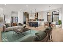 Open concept living space with modern furniture and hardwood floors at 679 E 16Th St, Indianapolis, IN 46202