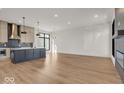 Spacious kitchen with island, stainless steel appliances, and hardwood floors at 679 E 16Th St, Indianapolis, IN 46202