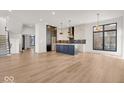 Modern kitchen features an island, stainless steel appliances, and hardwood floors at 679 E 16Th St, Indianapolis, IN 46202