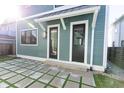 Modern back patio with gray square tiles and a view of a back door at 2133 N Talbott St, Indianapolis, IN 46202