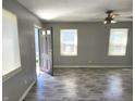 Living room with gray walls, wood-look floors, and ceiling fan at 3106 Newton Ave, Indianapolis, IN 46201