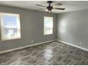 Bedroom with gray walls, wood-look floors, and ceiling fan at 3106 Newton Ave, Indianapolis, IN 46201