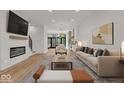 Open concept living room with modern furniture and a fireplace at 675 E 16Th St, Indianapolis, IN 46202