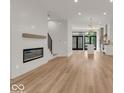 Bright and airy living room with hardwood floors and a fireplace at 675 E 16Th St, Indianapolis, IN 46202